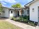 Landscaped walkway leads to front door of updated house at 8484 Sandberry Blvd, Orlando, FL 32819