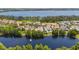 Lakefront community featuring beautiful homes with stunning water views and mature trees at 8581 Lake Nona Shore Dr, Orlando, FL 32827