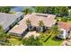 Expansive home with a tile roof, three-car garage, and lovely landscaping by the lake at 8581 Lake Nona Shore Dr, Orlando, FL 32827