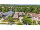 Aerial view featuring the house, a lake view, and a well-manicured lawn with mature trees at 8581 Lake Nona Shore Dr, Orlando, FL 32827