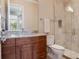 Bathroom featuring granite counters, wood cabinets, and a glass shower at 8581 Lake Nona Shore Dr, Orlando, FL 32827