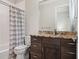Bathroom featuring wood cabinets, granite counters, and a shower/tub combo at 8581 Lake Nona Shore Dr, Orlando, FL 32827