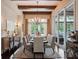 Elegant dining room with large windows, chandelier lighting, and seating for six at 8581 Lake Nona Shore Dr, Orlando, FL 32827