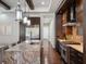 Modern kitchen with stainless steel appliances, a granite island, and sleek dark wood cabinets at 8581 Lake Nona Shore Dr, Orlando, FL 32827