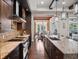 Stylish kitchen with stainless steel appliances, a granite island, and dark wood cabinetry at 8581 Lake Nona Shore Dr, Orlando, FL 32827