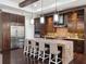 Open kitchen with granite island, stainless steel appliances, and dark wood cabinets at 8581 Lake Nona Shore Dr, Orlando, FL 32827