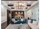 Open-concept living room and kitchen featuring dark wood floors, exposed beams, and modern appliances at 8581 Lake Nona Shore Dr, Orlando, FL 32827