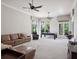 Open living room with large windows, plush seating, ceiling fans, and a pool table, ideal for entertaining at 8581 Lake Nona Shore Dr, Orlando, FL 32827