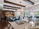 Bright living room with dark wood floors, exposed beams, and seamless indoor-outdoor living space at 8581 Lake Nona Shore Dr, Orlando, FL 32827