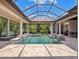 Beautiful pool area featuring a covered lanai, elegant water features, and views of the surrounding landscape at 8581 Lake Nona Shore Dr, Orlando, FL 32827