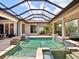 Tranquil pool area with a covered lanai, unique water features, and ample space for lounging and recreation at 8581 Lake Nona Shore Dr, Orlando, FL 32827