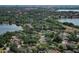 Expansive aerial view shows a neighborhood with lush trees, multiple lakes, and city skyline at 8830 Ladrido Ln, Orlando, FL 32836