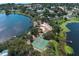 Aerial photo displays a lakefront community featuring amenities such as tennis courts and beach at 8830 Ladrido Ln, Orlando, FL 32836