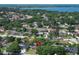 Neighborhood aerial view showcases mature trees, manicured lawns, and proximity to a serene lake at 8830 Ladrido Ln, Orlando, FL 32836