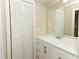 Bathroom with white cabinets, white countertops, white shaker doors and tile floors at 8830 Ladrido Ln, Orlando, FL 32836