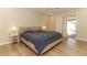 Bedroom featuring sliding glass doors, neutral walls, tile floor and comfortable bed at 8830 Ladrido Ln, Orlando, FL 32836