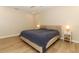 Bedroom with ensuite features tile floors, neutral walls, lamps and a comfy bed at 8830 Ladrido Ln, Orlando, FL 32836