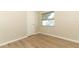 Cozy bedroom with wood-look flooring and a window at 8830 Ladrido Ln, Orlando, FL 32836
