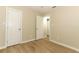 Bedroom with wood-look flooring and white doors at 8830 Ladrido Ln, Orlando, FL 32836