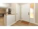 Bright entryway featuring a white front door, wood-look tile flooring, and views of kitchen at 8830 Ladrido Ln, Orlando, FL 32836