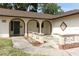 Inviting front entrance with decorative stonework and covered archways that adds curb appeal at 8830 Ladrido Ln, Orlando, FL 32836