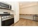 Kitchen with stainless steel gas range oven, white cabinets, wood countertops and a spacious floor at 8830 Ladrido Ln, Orlando, FL 32836