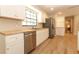 Bright kitchen features stainless steel appliances, white cabinets and butcher block countertops at 8830 Ladrido Ln, Orlando, FL 32836