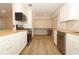 Spacious kitchen with stainless steel appliances, wood-look floors, white cabinets and long countertops at 8830 Ladrido Ln, Orlando, FL 32836