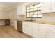 Bright kitchen features white cabinets, butcher block countertops, stainless steel appliances and wood-look flooring at 8830 Ladrido Ln, Orlando, FL 32836