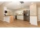 Updated kitchen featuring stainless steel appliances, bright white cabinets, and a breakfast bar at 8830 Ladrido Ln, Orlando, FL 32836