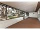 Enclosed patio features a full screen and open views to the lush landscaping at 8830 Ladrido Ln, Orlando, FL 32836