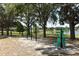 Outdoor workout area with exercise machines surrounded by mature trees and a lake at 8830 Ladrido Ln, Orlando, FL 32836