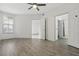 Comfortable bedroom with wood-look flooring, a ceiling fan, and ample natural light at 911 N Orange Ave # 409, Orlando, FL 32801