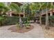 Charming courtyard garden with seating area, stone pathways, and mature trees at 911 N Orange Ave # 409, Orlando, FL 32801