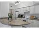 Bright kitchen featuring white cabinets, laminate countertops, and modern appliances at 911 N Orange Ave # 409, Orlando, FL 32801