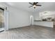 Open living room with luxury vinyl floors connecting to a kitchen and a balcony at 911 N Orange Ave # 409, Orlando, FL 32801