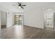 Bright living room with luxury vinyl floors, a ceiling fan, and an ensuite bathroom at 911 N Orange Ave # 409, Orlando, FL 32801