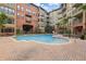Inviting pool with ample seating surrounded by lush landscaping at this multi-story residential complex at 911 N Orange Ave # 409, Orlando, FL 32801