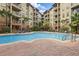 Beautiful swimming pool surrounded by lounge chairs and lush landscaping for relaxation at 911 N Orange Ave # 409, Orlando, FL 32801