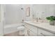 Bathroom featuring combination tub/shower with tile surround, toilet, and vanity with modern fixtures at 9472 Se 152Nd Pl, Summerfield, FL 34491