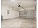 Spacious two-car garage with concrete flooring and ample space for storage at 9472 Se 152Nd Pl, Summerfield, FL 34491