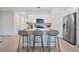 Modern kitchen featuring white cabinets, stainless steel appliances, a center island with seating, and sleek finishes at 9472 Se 152Nd Pl, Summerfield, FL 34491