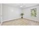 An airy bedroom with neutral walls, wood-look floors, and a ceiling fan at 956 Salt Pond Pl # 207, Altamonte Springs, FL 32714