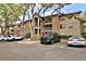 Complex exterior with lush trees and ample parking at 956 Salt Pond Pl # 207, Altamonte Springs, FL 32714