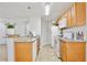 Bright kitchen with wood cabinets, granite countertops, and white appliances at 956 Salt Pond Pl # 207, Altamonte Springs, FL 32714