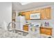 A close-up view of a kitchen showcasing granite countertops and white appliances at 956 Salt Pond Pl # 207, Altamonte Springs, FL 32714