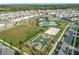 Aerial view of Storey Park amenities and homes with basketball court, pool, and sand volleyball at 11296 Listening Dr, Orlando, FL 32832