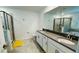 Modern bathroom with double sinks, large mirror, walk-in shower, and soaking tub at 11296 Listening Dr, Orlando, FL 32832