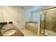 Elegant bathroom featuring double sinks, a soaking tub, and a separate glass-enclosed shower at 11296 Listening Dr, Orlando, FL 32832