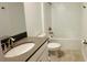 Clean bathroom featuring a shower-tub combo, toilet, and sink with grey countertop at 11296 Listening Dr, Orlando, FL 32832